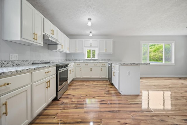 10610 State Route 7, Worcester, NY 12149 - kitchen with appliances with stainless steel finishes, under cabinet range hood, a textured ceiling, light wood-style flooring, and white cabinets