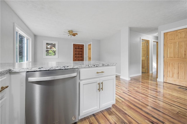 10610 State Route 7, Worcester, NY 12149 - kitchen featuring dishwasher, light wood finished floors, white cabinets, and light stone countertops