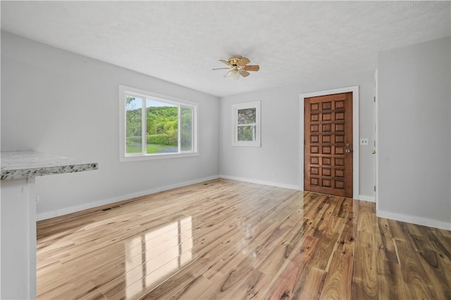 10610 State Route 7, Worcester, NY 12149 - unfurnished room with wood finished floors, baseboards, a ceiling fan, and a textured ceiling