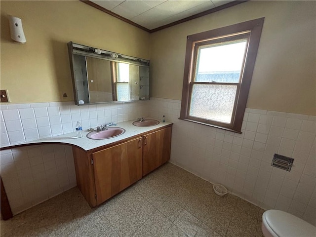 1227 Lake St, Elmira-City, NY 14901 - full bathroom featuring tile walls, wainscoting, double vanity, ornamental molding, and toilet