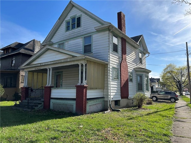 1227 Lake St, Elmira-City, NY 14901 - view of front of house featuring covered porch, a chimney, and a front yard