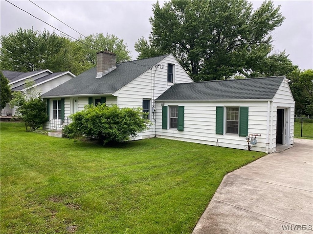 5780 Sheridan Dr, Amherst, NY 14221 - view of front of house with roof with shingles, a chimney, and a front yard