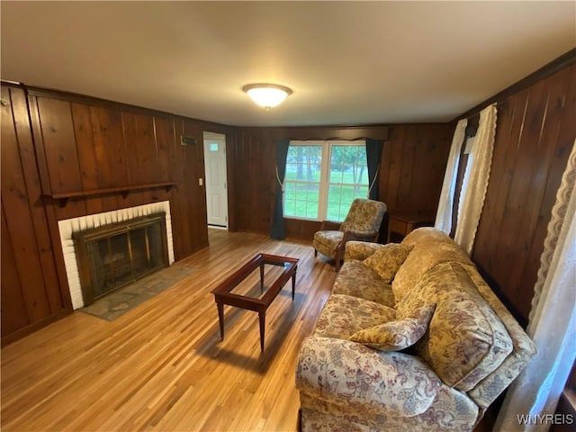 5780 Sheridan Dr, Amherst, NY 14221 - living room with light wood-style floors, a fireplace, and wood walls