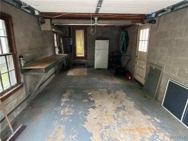 5780 Sheridan Dr, Amherst, NY 14221 - garage with freestanding refrigerator and concrete block wall
