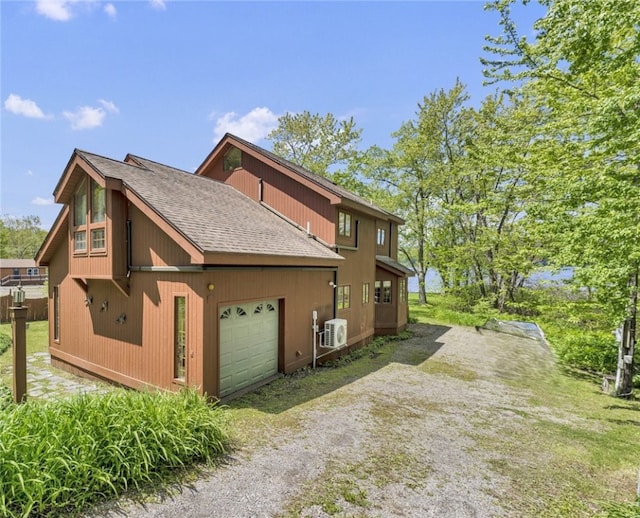 2555 County Highway 22, Richfield, NY 13439 - view of side of property featuring a cooling unit, a shingled roof, driveway, and a garage