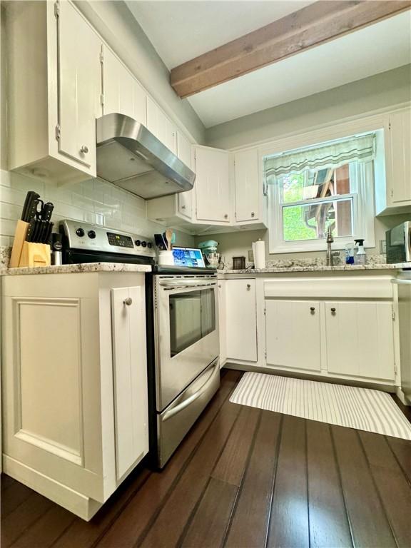 7 Overbrook Dr, Owego, NY 13732 - kitchen with wall chimney range hood, appliances with stainless steel finishes, white cabinets, dark wood-type flooring, and beamed ceiling