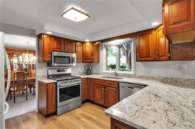 4640 Pine Mnr Unit W, Clarence, NY 14031 - kitchen featuring stainless steel appliances, brown cabinetry, a sink, light stone countertops, and recessed lighting