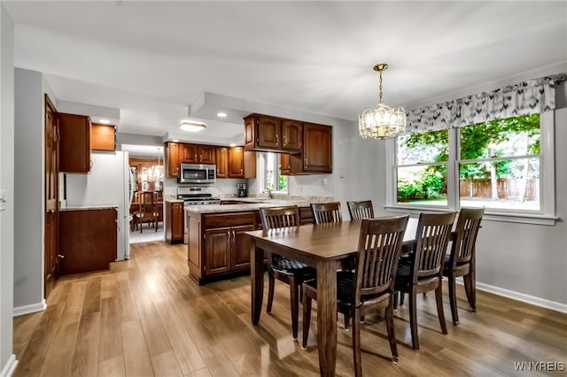 4640 Pine Mnr Unit W, Clarence, NY 14031 - dining area featuring a chandelier, light wood-style flooring, and baseboards