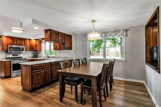 4640 Pine Mnr Unit W, Clarence, NY 14031 - kitchen featuring stainless steel appliances, a sink, wood finished floors, a chandelier, and recessed lighting
