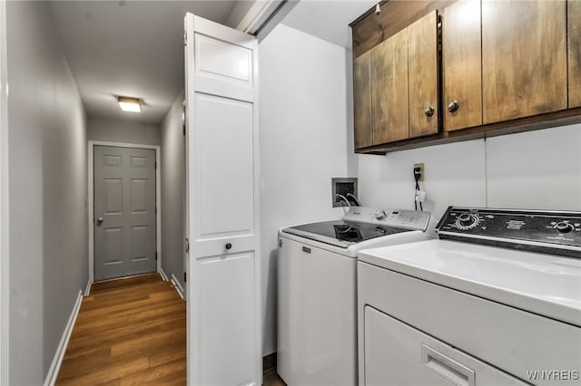 4640 Pine Mnr Unit W, Clarence, NY 14031 - washroom with cabinet space, wood finished floors, washing machine and clothes dryer, and baseboards