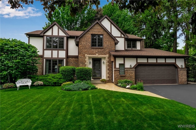 4640 Pine Mnr Unit W, Clarence, NY 14031 - tudor home featuring stucco siding, driveway, a front yard, an attached garage, and brick siding