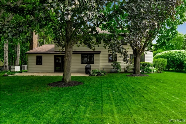 4640 Pine Mnr Unit W, Clarence, NY 14031 - view of front of house with a chimney, a patio, and a front lawn