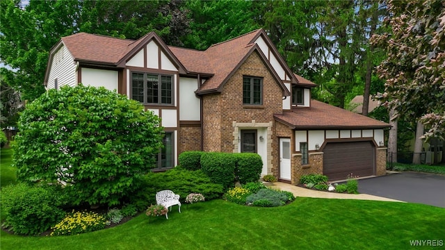 4640 Pine Mnr Unit W, Clarence, NY 14031 - english style home with brick siding, asphalt driveway, stucco siding, and a front lawn