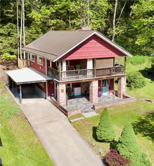 25 Woodside Ave, Oneonta-City, NY 13820 - rustic home with driveway, a wooden deck, a forest view, a carport, and metal roof