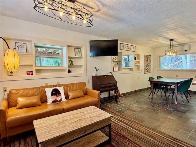 25 Woodside Ave, Oneonta-City, NY 13820 - living area featuring a textured ceiling, a chandelier, baseboards, built in shelves, and dark stone finish floors