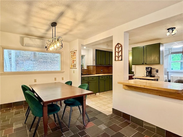 25 Woodside Ave, Oneonta-City, NY 13820 - dining area with washing machine and dryer, baseboards, and a textured ceiling