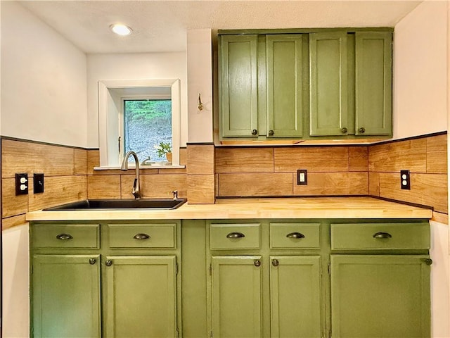 25 Woodside Ave, Oneonta-City, NY 13820 - kitchen featuring green cabinets, a sink, and a wainscoted wall