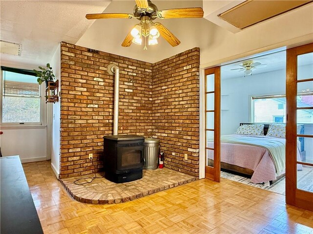 25 Woodside Ave, Oneonta-City, NY 13820 - unfurnished living room featuring a wood stove, ceiling fan, and baseboards