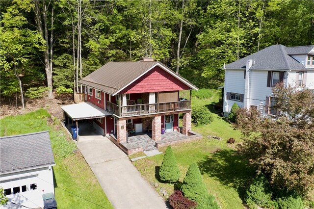 25 Woodside Ave, Oneonta-City, NY 13820 - view of front of home featuring a carport, a front yard, concrete driveway, a wooden deck, and a chimney