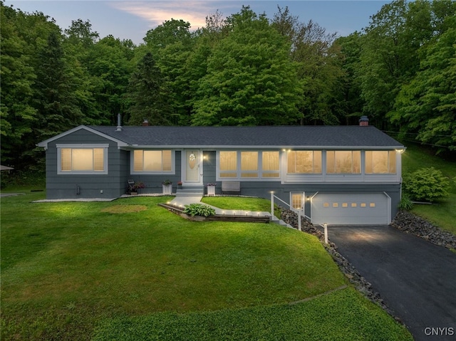11245 Bell Hill Rd, Deerfield, NY 13502 - ranch-style home with an attached garage, driveway, a lawn, a chimney, and a view of trees