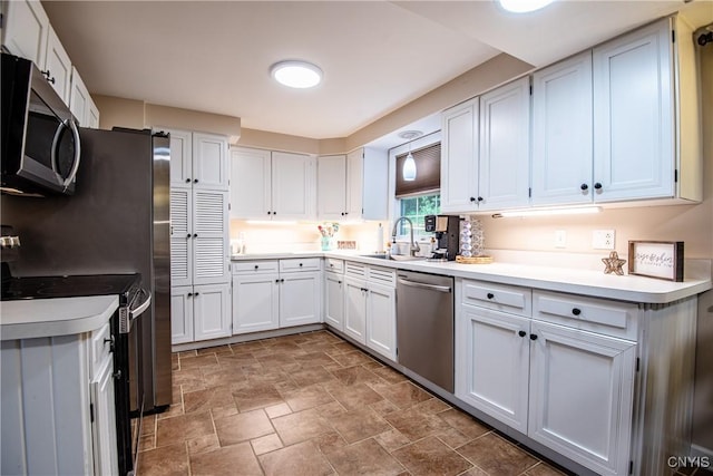 11245 Bell Hill Rd, Deerfield, NY 13502 - kitchen featuring stainless steel appliances, a sink, stone finish floors, white cabinetry, and light countertops