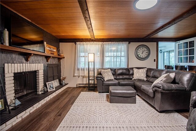 11245 Bell Hill Rd, Deerfield, NY 13502 - living area featuring baseboard heating, wood ceiling with exposed beams, wood finished floors, and a brick fireplace