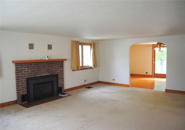 202 Birch St, Kane Boro, PA 16735 - unfurnished living room with carpet floors, healthy amount of natural light, arched walkways, and a fireplace