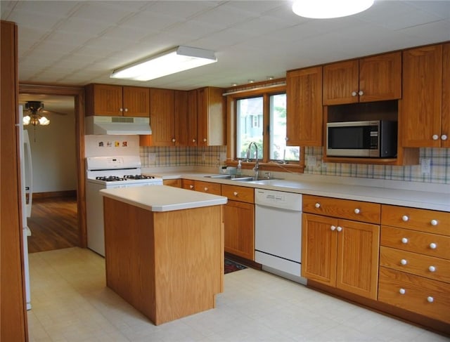 202 Birch St, Kane Boro, PA 16735 - kitchen featuring white appliances, under cabinet range hood, a kitchen island, light countertops, and brown cabinets