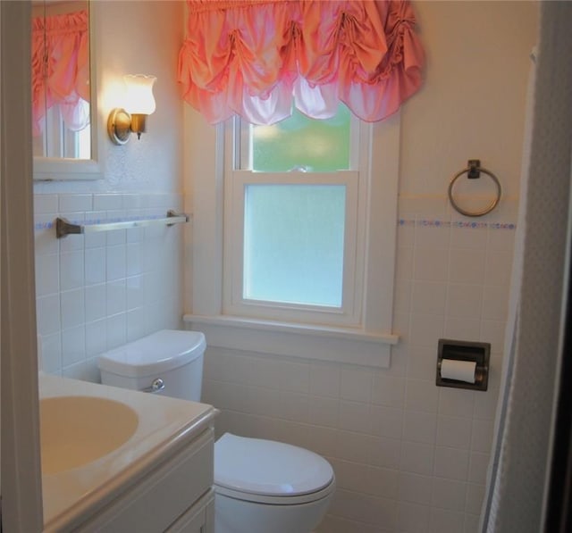 202 Birch St, Kane-Borough, PA 16735 - bathroom with tile walls, toilet, healthy amount of natural light, vanity, and a wainscoted wall