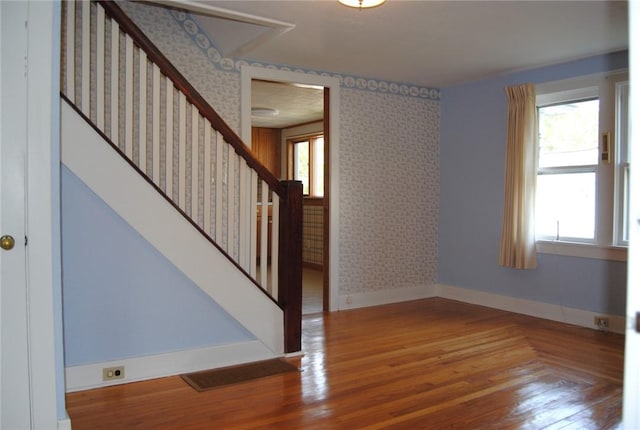 202 Birch St, Kane Boro, PA 16735 - empty room with wallpapered walls, stairway, and wood finished floors