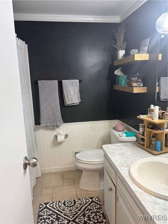 1056 Charlesgate Cir, Amherst, NY 14051 - bathroom with toilet, vanity, tile patterned floors, ornamental molding, and a wainscoted wall