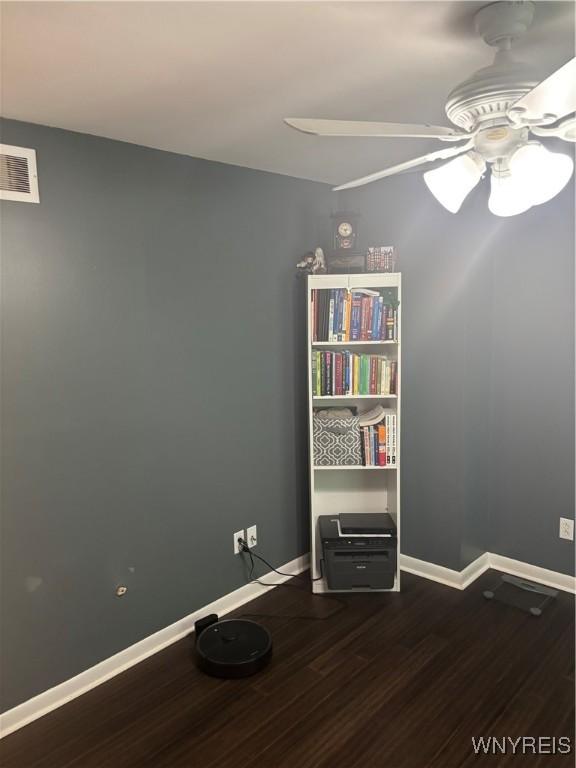 1056 Charlesgate Cir, Amherst, NY 14051 - unfurnished room with wood finished floors, ceiling fan, and baseboards