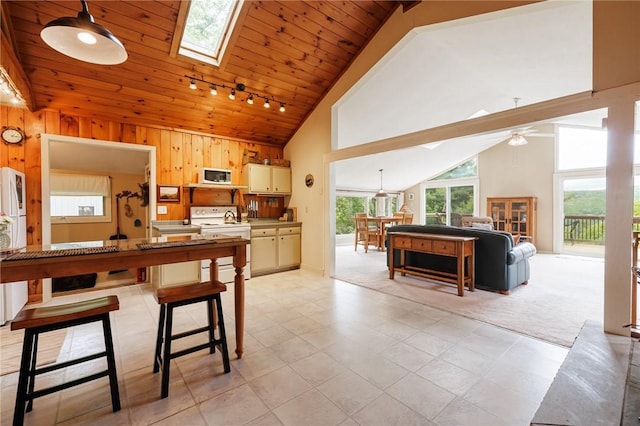 4255 Parish Hill Rd, Italy, NY 14512 - kitchen with white appliances, a ceiling fan, wood walls, a skylight, and wood ceiling