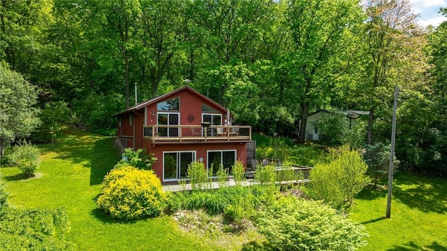 4255 Parish Hill Rd, Italy, NY 14512 - back of property featuring a lawn, a deck, and a wooded view