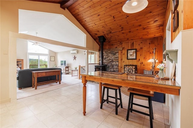 4255 Parish Hill Rd, Italy, NY 14512 - kitchen with a wood stove, ceiling fan, a wall mounted AC, light carpet, and open floor plan