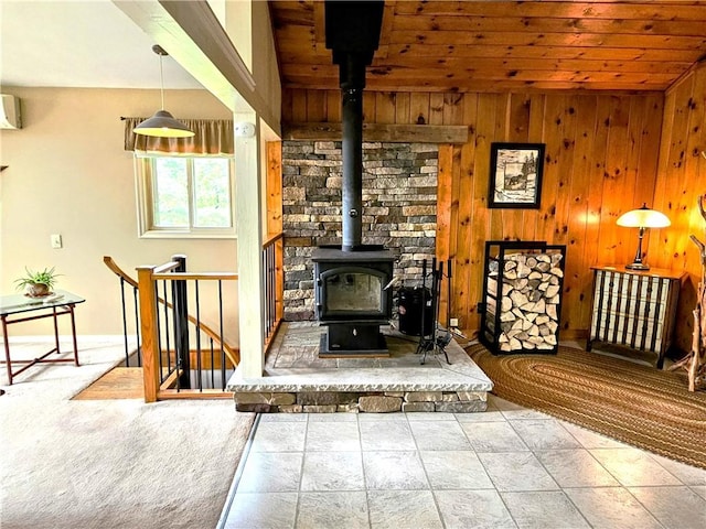 4255 Parish Hill Rd, Italy, NY 14512 - living room featuring a wood stove, wooden walls, baseboards, wooden ceiling, and a wall unit AC