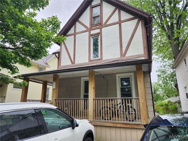 237 Tremont St, North Tonawanda, NY 14120 - tudor-style house featuring stucco siding and covered porch