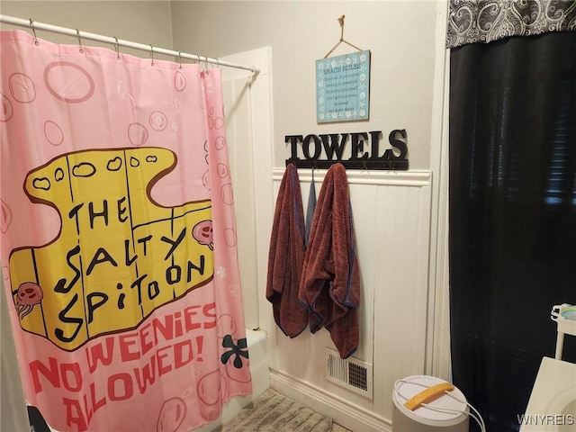 237 Tremont St, North Tonawanda, NY 14120 - bathroom featuring a wainscoted wall and shower / bathtub combination with curtain