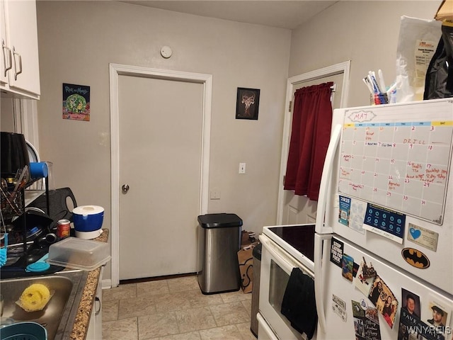 237 Tremont St, North Tonawanda, NY 14120 - kitchen with white appliances, light stone finish flooring, and white cabinetry