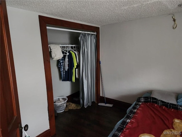 158 Keil St, North Tonawanda, NY 14120 - bedroom featuring a textured ceiling, wood finished floors, a closet, and baseboards