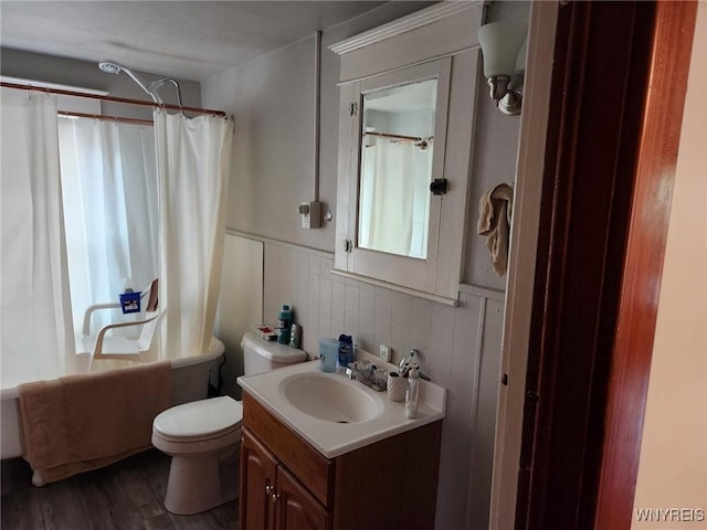 158 Keil St, North Tonawanda, NY 14120 - bathroom featuring vanity, toilet, a wainscoted wall, wood finished floors, and shower / tub combo with curtain
