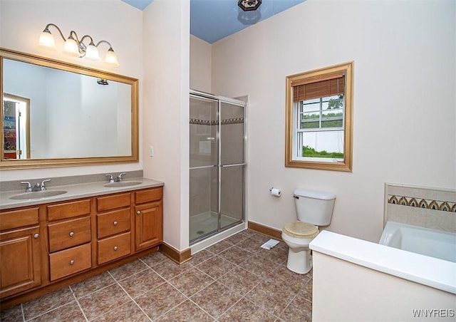 4786 Ormonde Dr, Cazenovia, NY 13035 - bathroom with double vanity, a stall shower, toilet, baseboards, and a tub to relax in