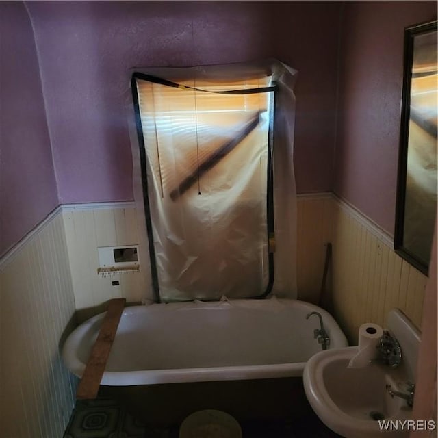 360 Watson St, Buffalo, NY 14212 - bathroom featuring a bathtub and a wainscoted wall