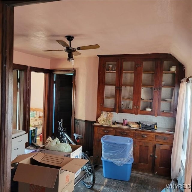 360 Watson St, Buffalo, NY 14212 - kitchen with a ceiling fan, glass insert cabinets, dark wood finished floors, wainscoting, and decorative backsplash