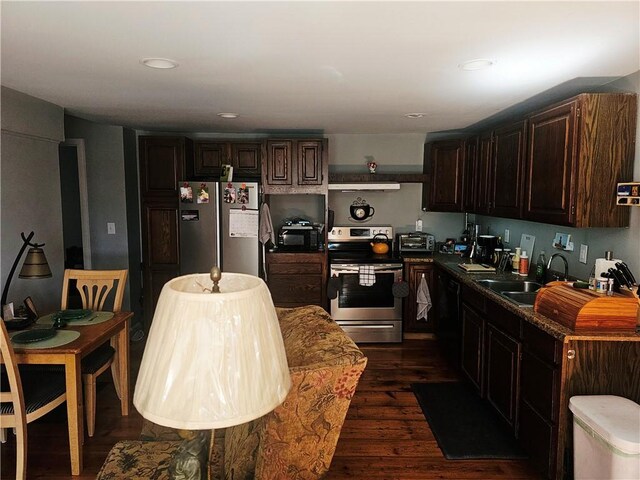 2968 County Highway 11, Hartwick, NY 13348 - kitchen with stainless steel appliances, dark wood-style flooring, a sink, dark brown cabinets, and under cabinet range hood