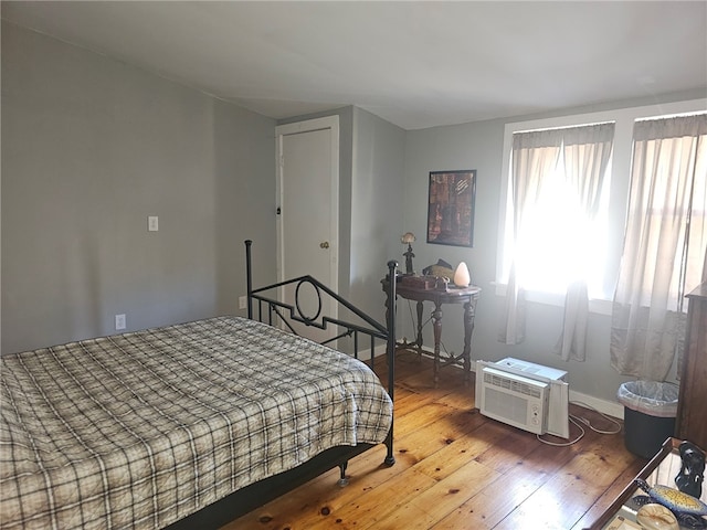 2968 County Highway 11, Hartwick, NY 13348 - bedroom with wood-type flooring, baseboards, and a wall mounted AC