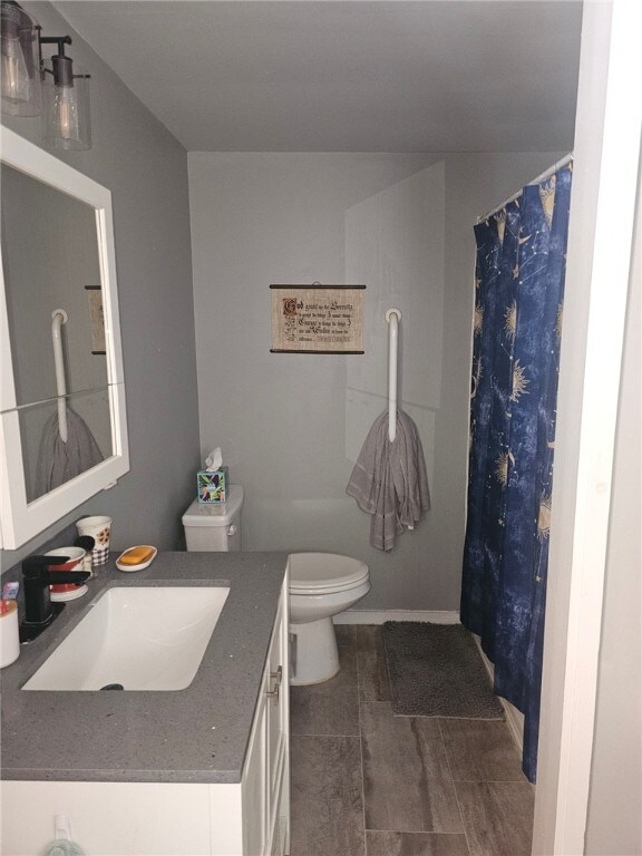 2968 County Highway 11, Hartwick, NY 13348 - bathroom featuring toilet, vanity, and a shower with shower curtain