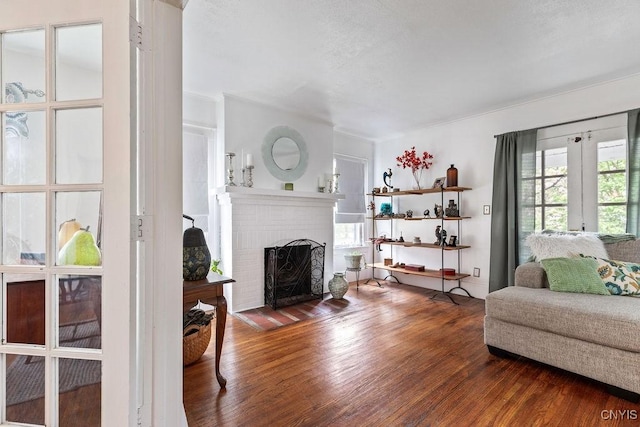 173 Mosley Dr Unit 1, Syracuse, NY 13206 - living area with a brick fireplace and wood finished floors