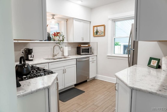 25 Kenton Rd, Tonawanda-Town, NY 14217 - kitchen with stainless steel dishwasher, a sink, tasteful backsplash, and baseboards
