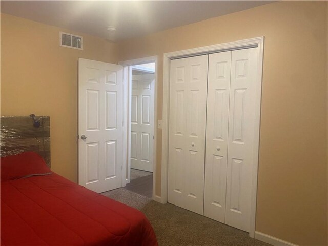6 Gemini Cir, Gates, NY 14606 - bedroom with dark carpet, a closet, and baseboards